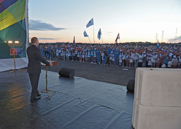 Russia's President Vladimir Putin addresses people as he visits a construction site of the stadium which is expected to host soccer matches of the 2018 World Cup in the city of Samara