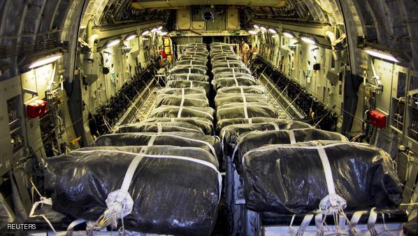 Water bundles align a C-17 Globemaster III cargo plane at Al Udeid Air Base, Qatar, prior to a humanitarian air drop over Iraq