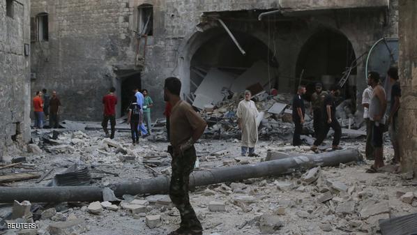 People inspect a site hit by what activists said was an airstrike by forces loyal to Syria's President Bashar al-Assad in Qadi Askar district in Aleppo