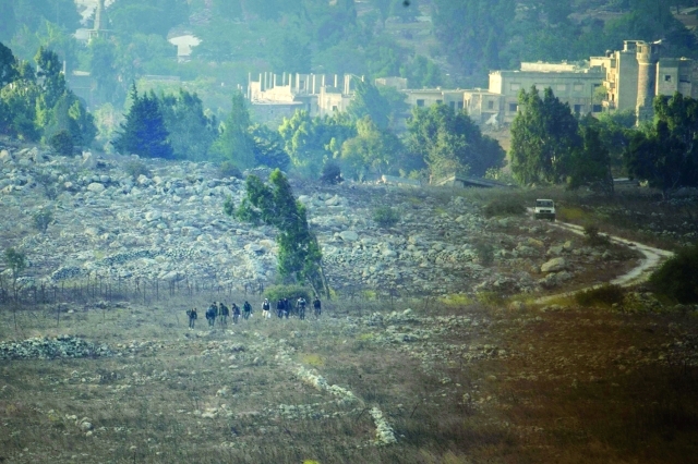 Rebel fighters are seen in Syria near the border fence with the Israeli-occupied Golan Heights