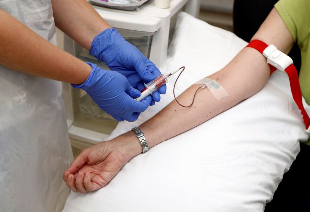 Volunteer Ruth Atkins has blood taken before receiving an injection of the Ebola vaccine at the Oxford Vaccine Group Centre for Clinical Vaccinology and Tropical Medicine (CCVTM) in Oxford