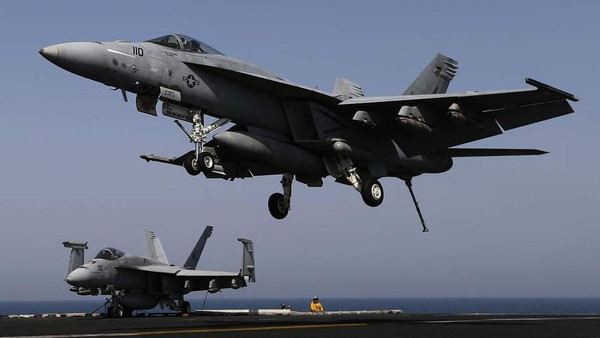 A F/A-18E comes in to land onboard USS George H.W. Bush in the Gulf