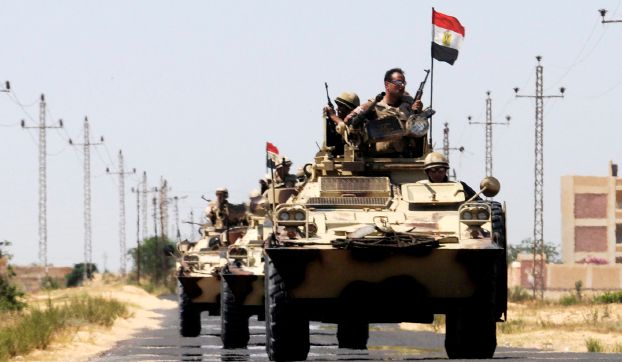 Soldiers in military vehicles proceed towards al-Jura district in El-Arish city from Sheikh Zuwaid
