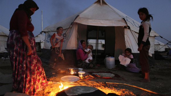 File photo of a woman from minority Yazidi sect, who fled violence in Iraqi town of Sinjar, making bread at Bajed Kadal refugee camp, southwest of Dohuk province