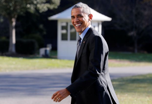 U.S. President Obama walks back inside the White House to retrieve his BlackBerry device, after boarding Marine One on the South Lawn of the White House in Washington