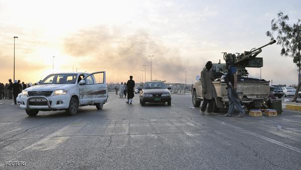 File photo of fighters of the Islamic State of Iraq and the Levant (ISIL) standing guard at a checkpoint in the northern Iraq city of Mosul