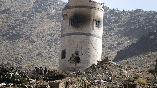 Houthi fighters stand near damaged guard post at Presidential Guards barracks they took over on mountain overlooking Presidential Palace in Sanaa