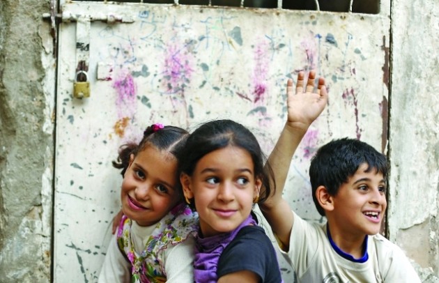 Children pose for a photo as they play in the old quarter of Yemen's capital Sanaa