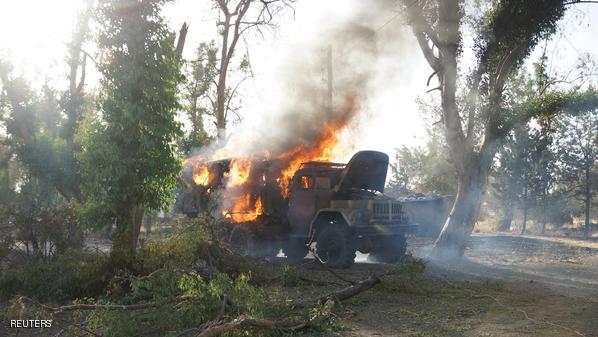 A military truck belonging to forces loyal to Syrian president Bashar Al-Assad is seen on fire at the Brigade 52 military base after it was captured by the Free Syrian Army in Daraa, Syria